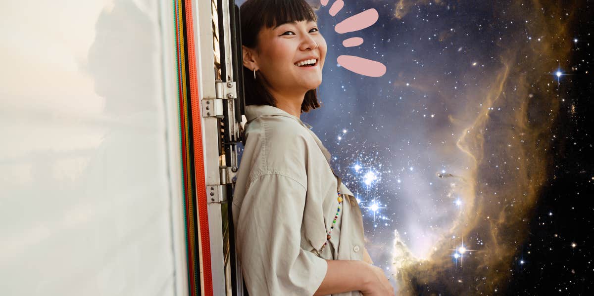 woman leaning against airstream camper with a wild space image in the background