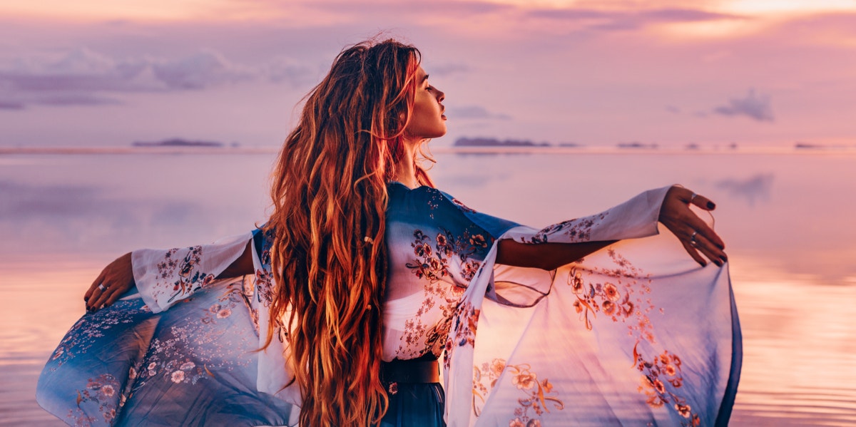 woman with flowy dress by the water