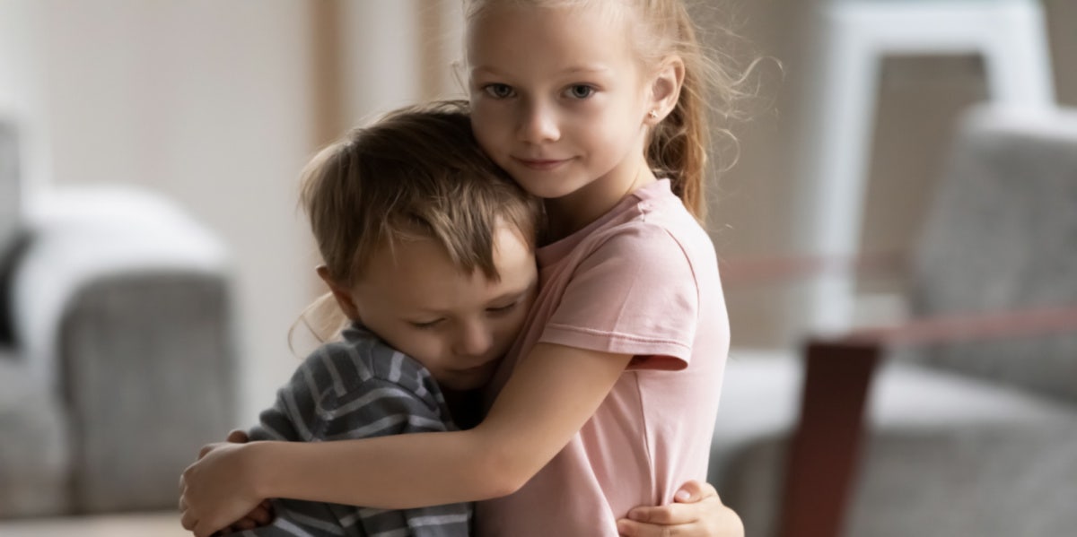 brother and sister hugging