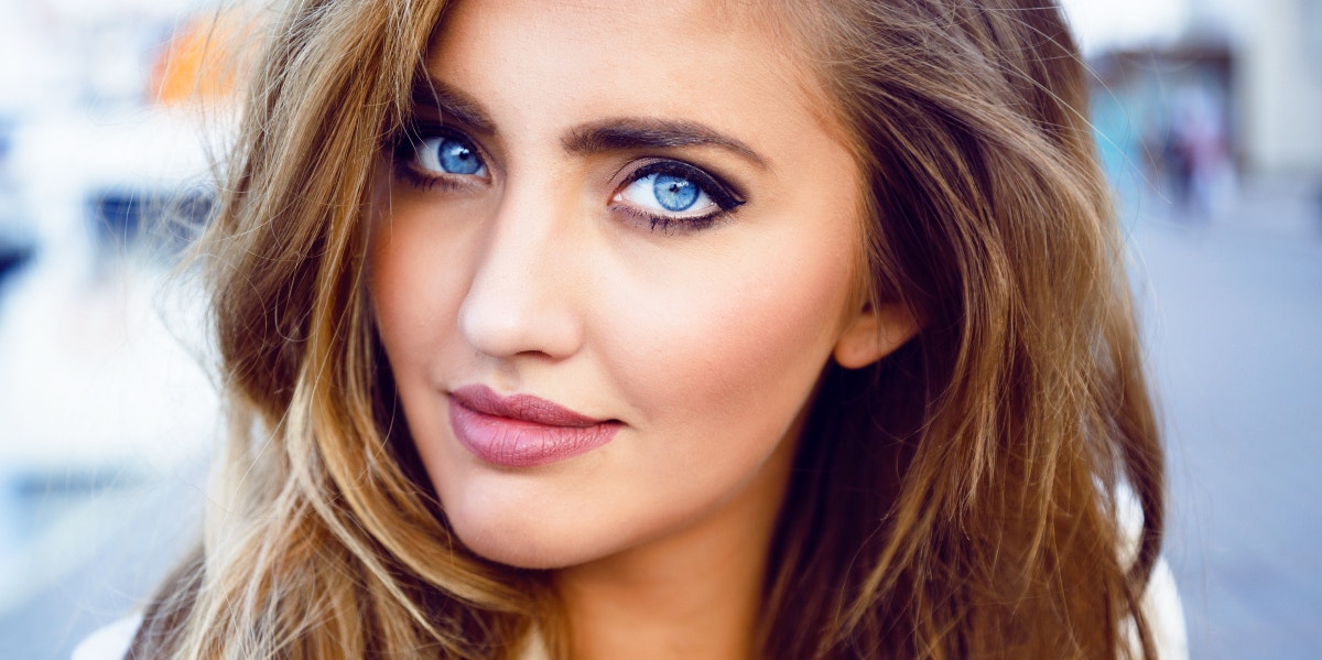 woman with blue eyes staring and smirking