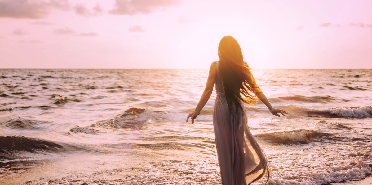 woman at ocean in sunset