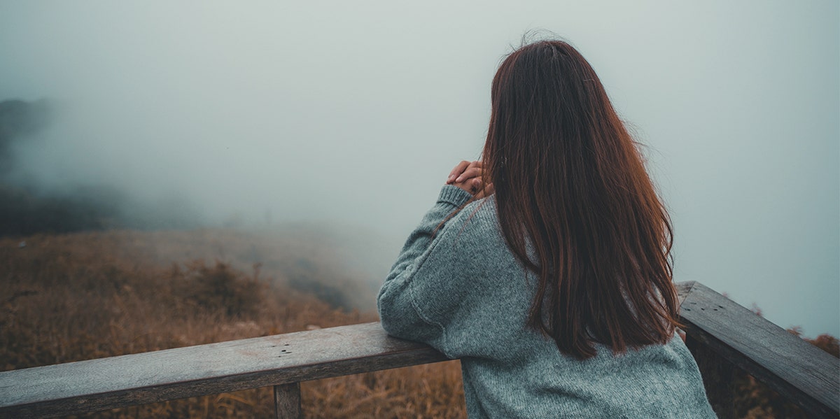 woman looking out at fog