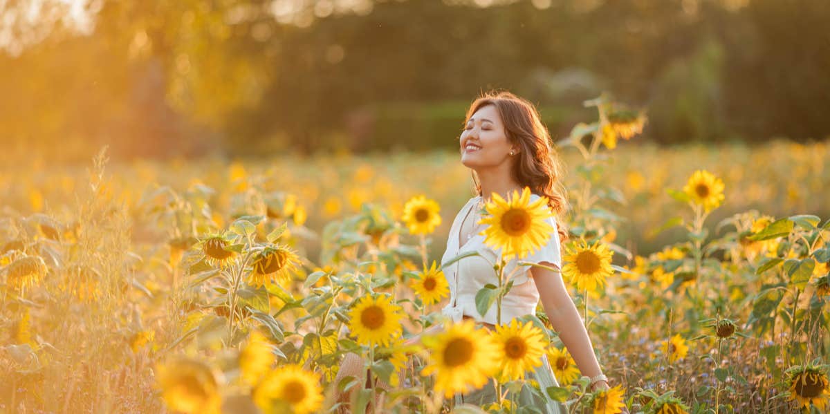 How To Start The New And Improved Life You’ve Always Wanted woman in a field of sunflowers
