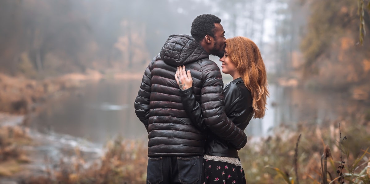 couple hugging by a lake