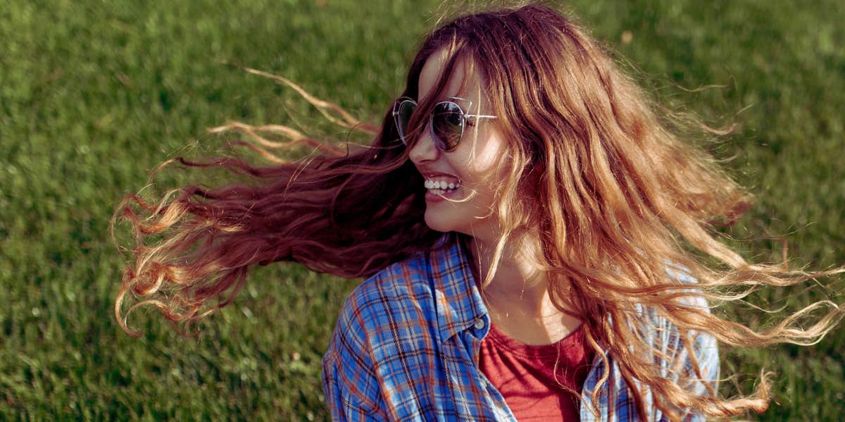 hipster girl on sitting on grass 