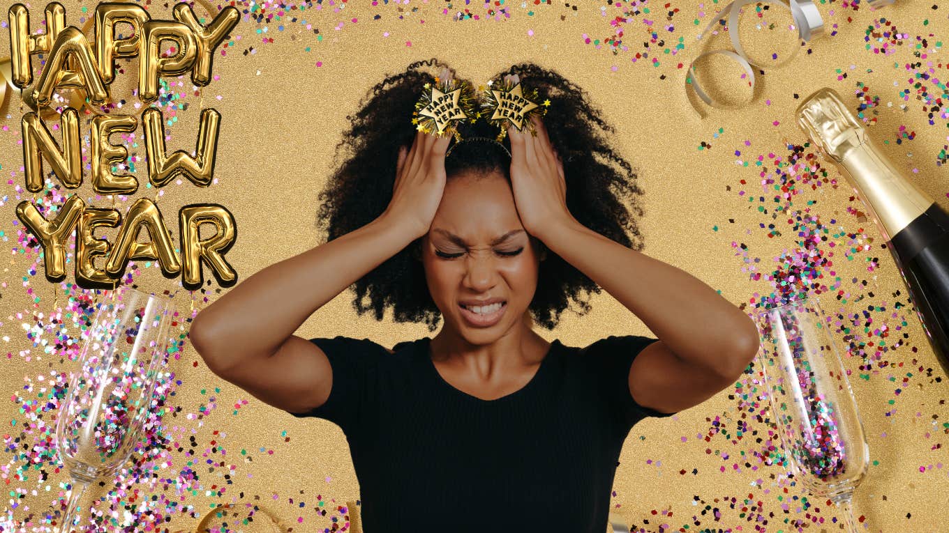 Woman looking stressed out in front of a New Year's Eve party backdrop
