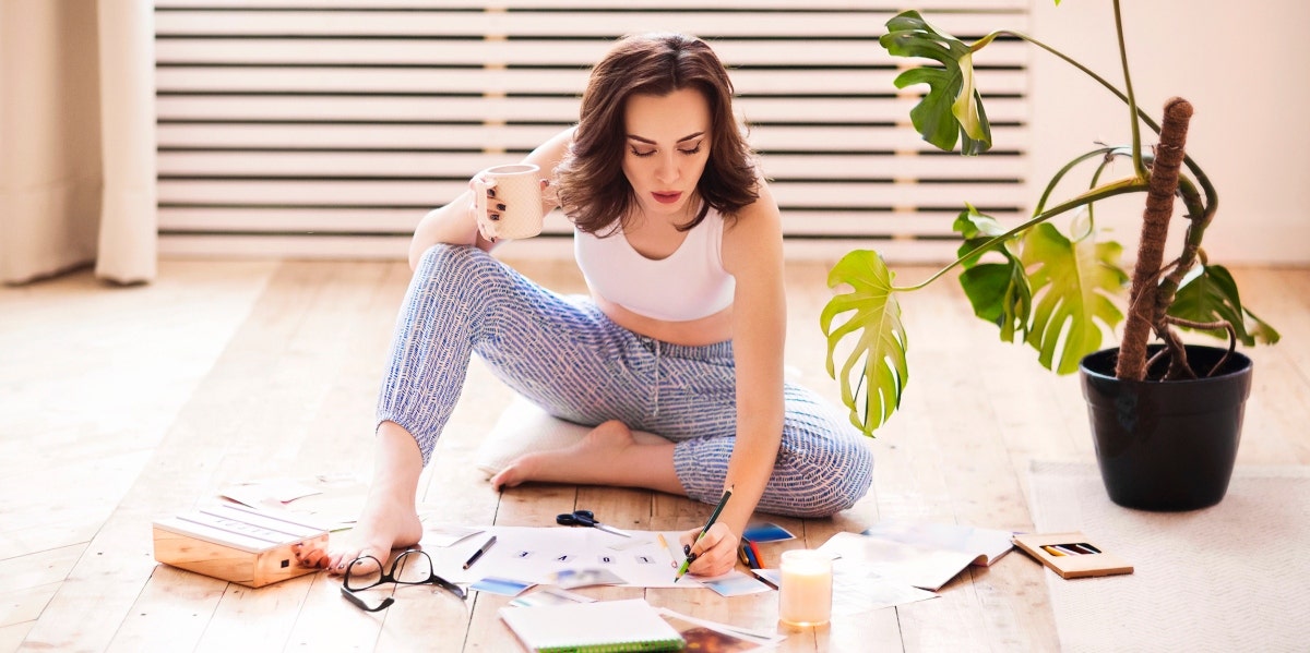 New Year's Vision board woman on the floor creating a vision board