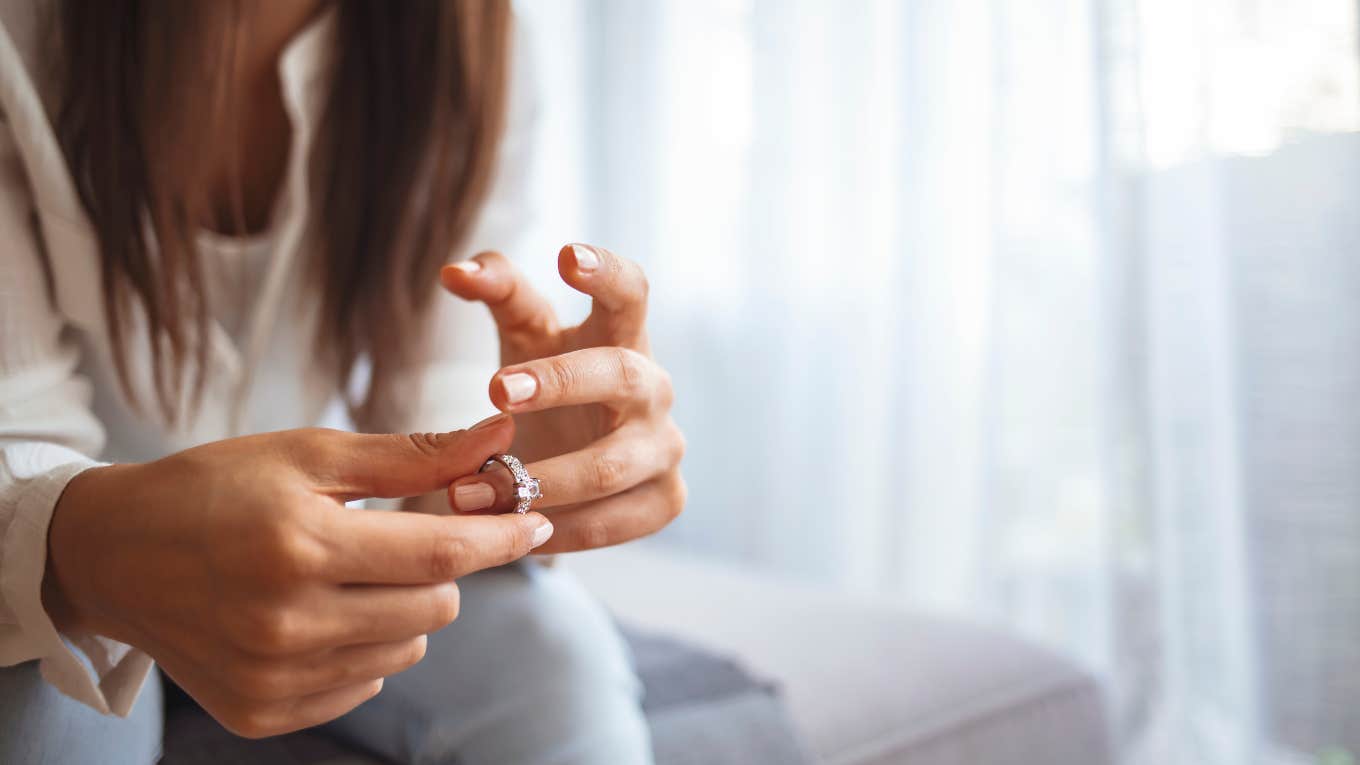 woman taking off wedding ring