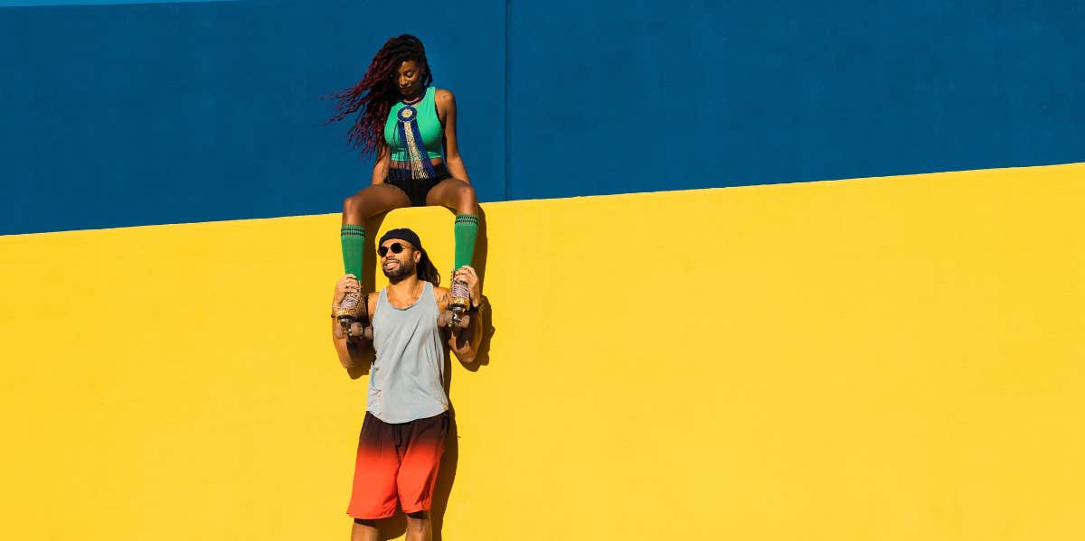 man and woman wearing roller skates