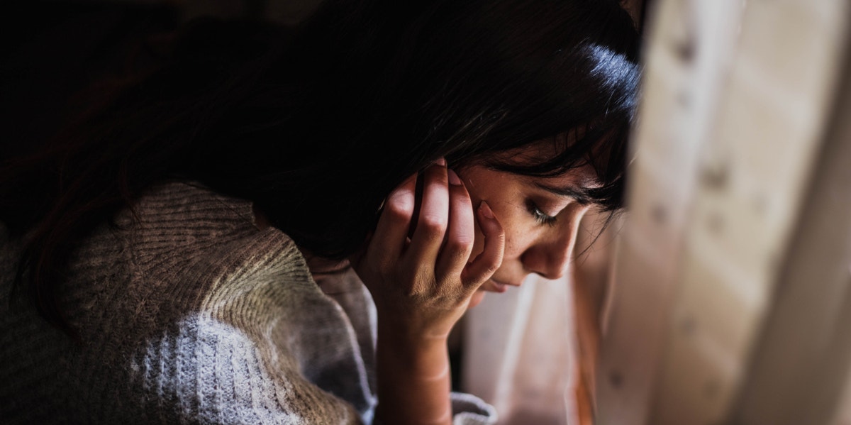 Let's Normalize 'It's Okay Not To Be Okay' For Our Anxious Friends woman looking down