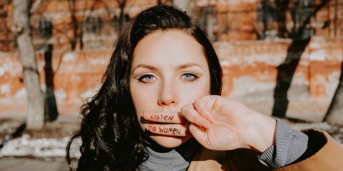 woman with hand over her mouth