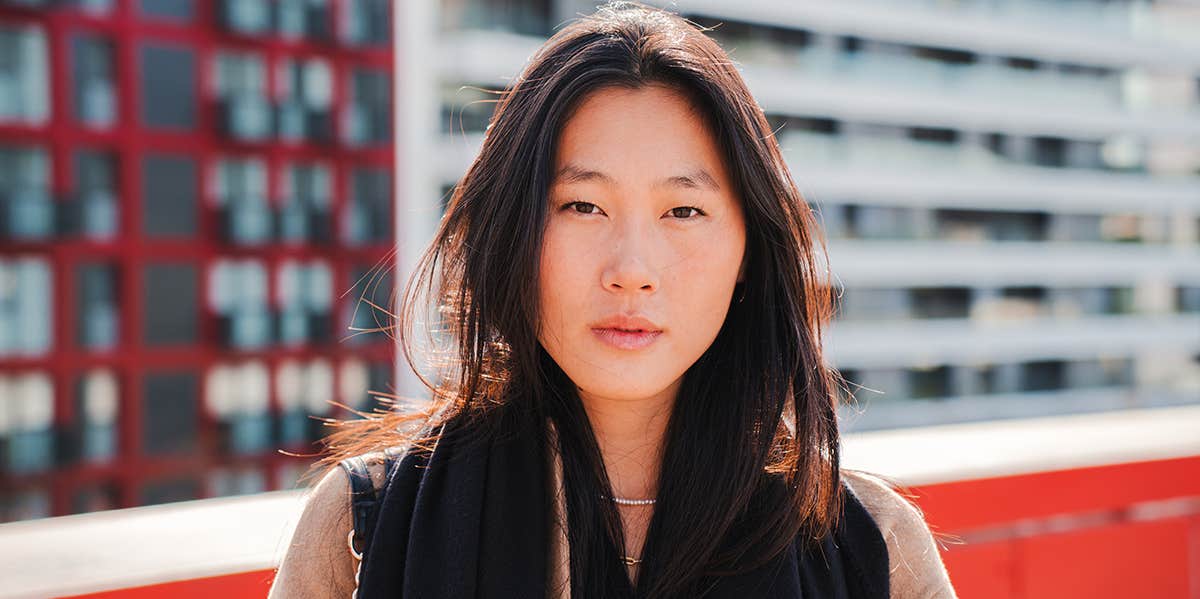 Attention: These 5 Things Are Absolutely Not Real Love woman on rooftop looking somber