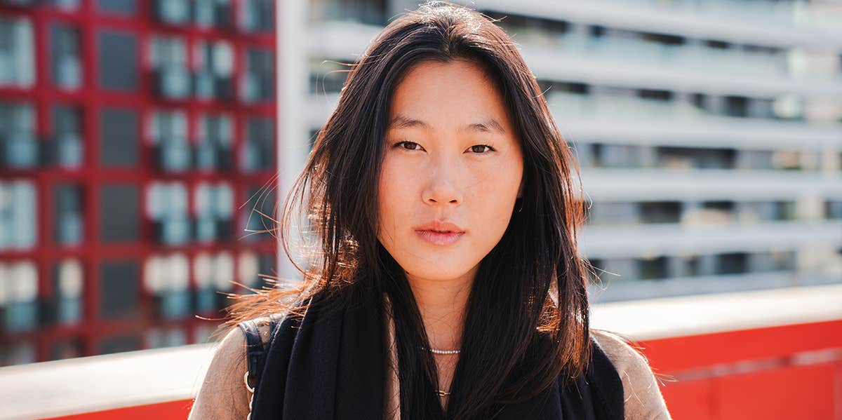 woman on rooftop looking somber