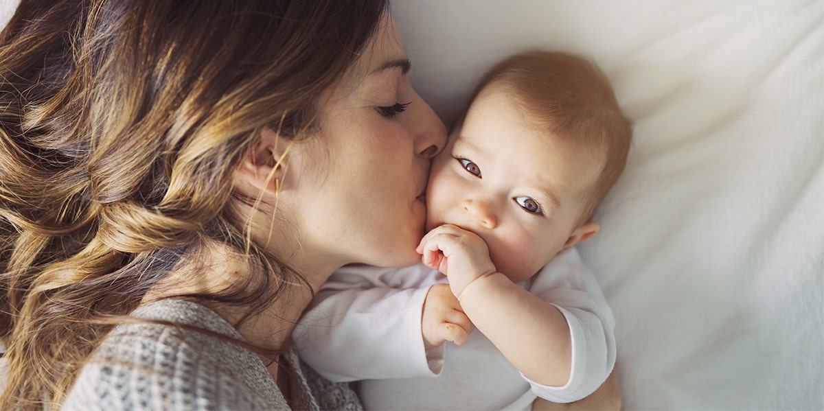 mother kissing baby