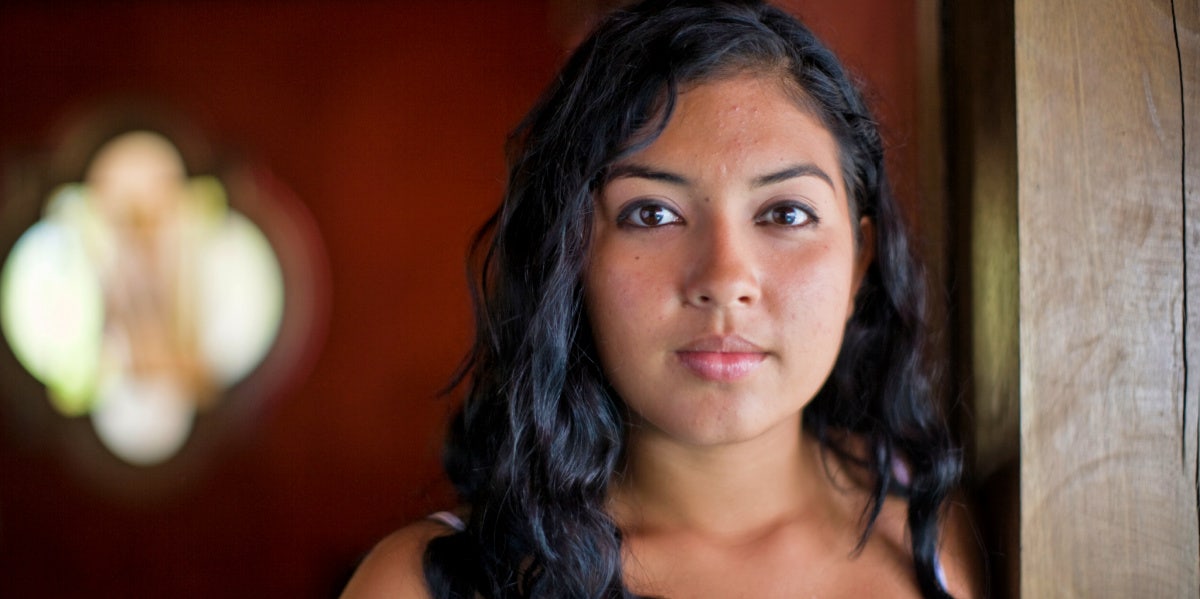 stoic woman with curly hair staring ahead