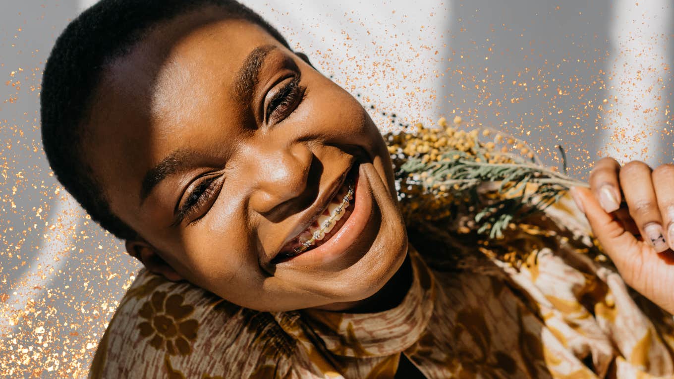 Woman smiling holding flowers