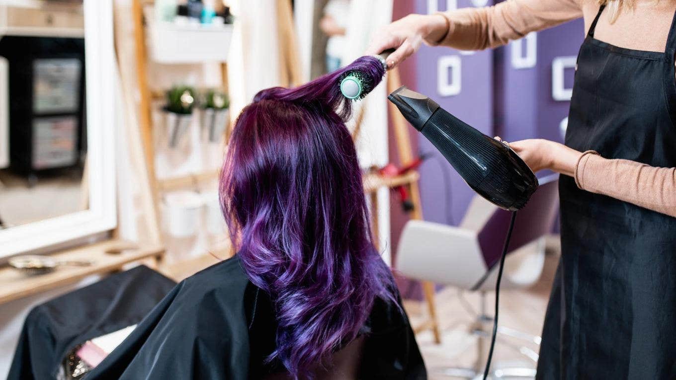 woman at salon with bright purple hair