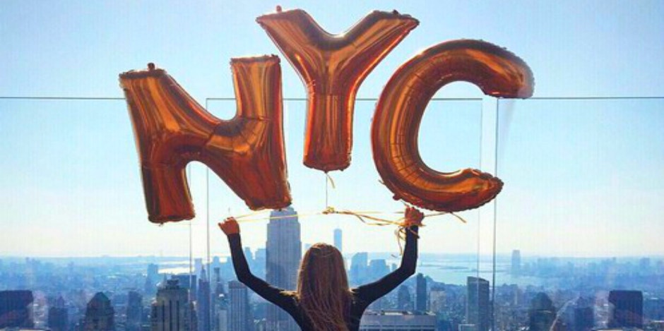 girl holding nyc sign