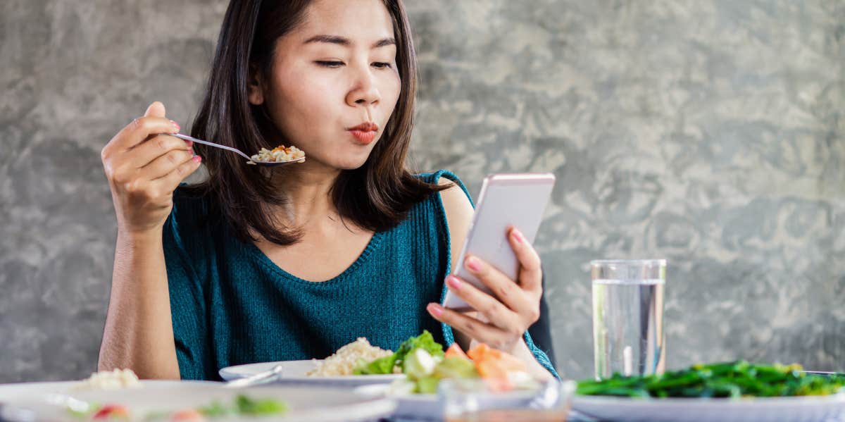 woman eyeing phone suspiciously