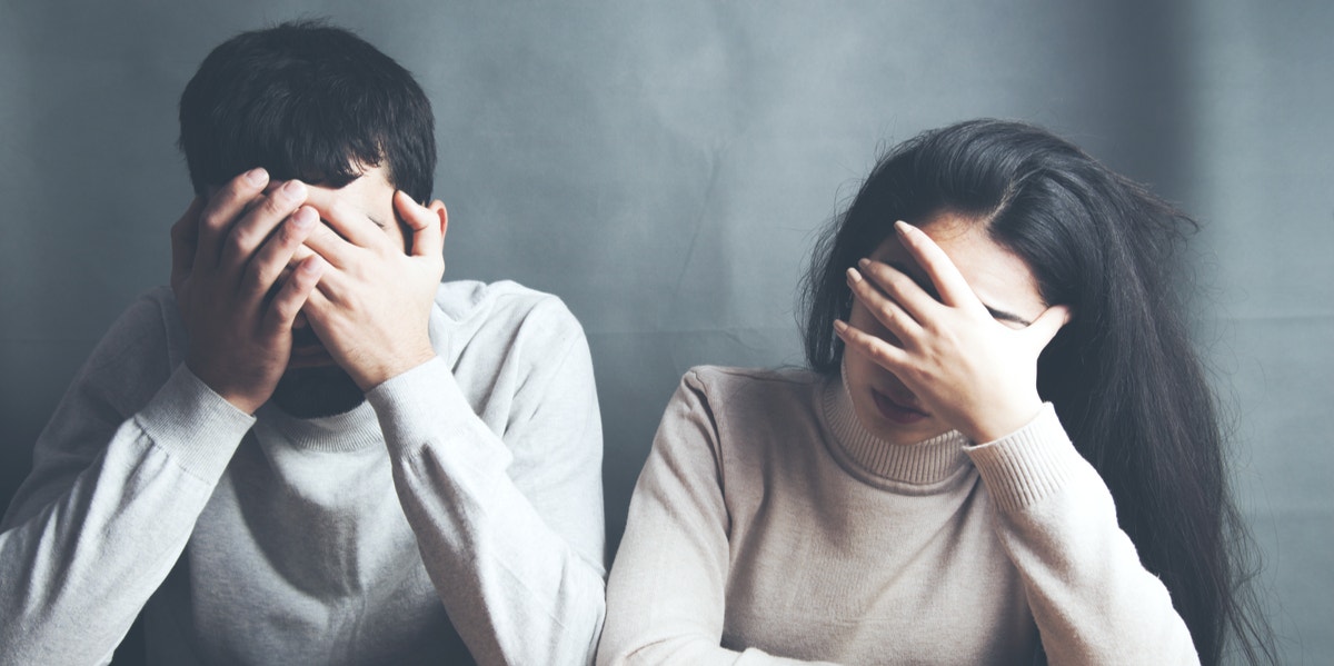 The Odd Pattern I Discovered After Being In 10 Failed Relationships woman and man with hands on forehead in frustration