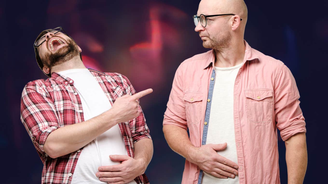 Why Old Friendships Can Be Like Scabs On Mostly Healed Wounds Man laughs out loud, holds on to stomach and points a finger at another person who is upset by him