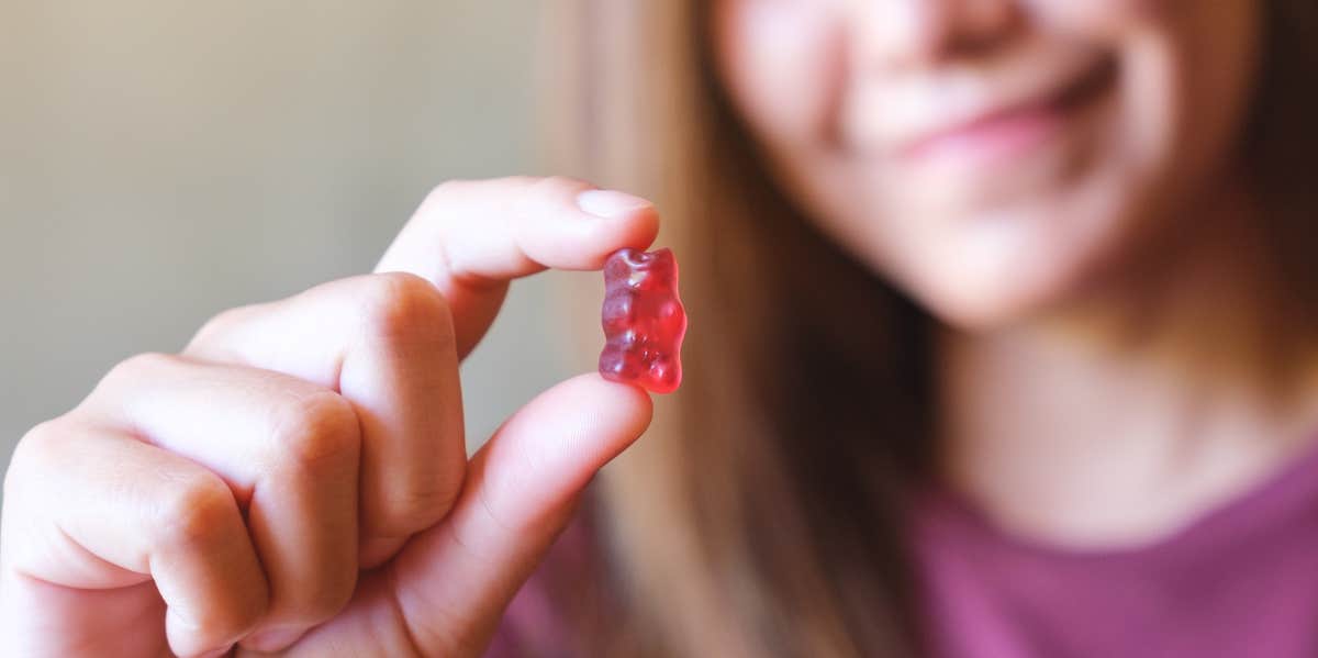 woman holding gummy bear