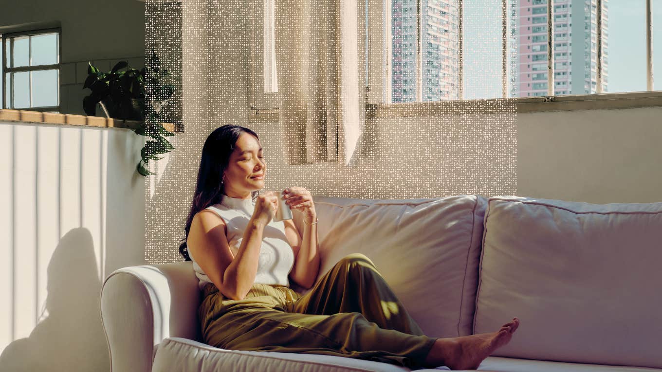 Woman taking a mindful moment on her couch 