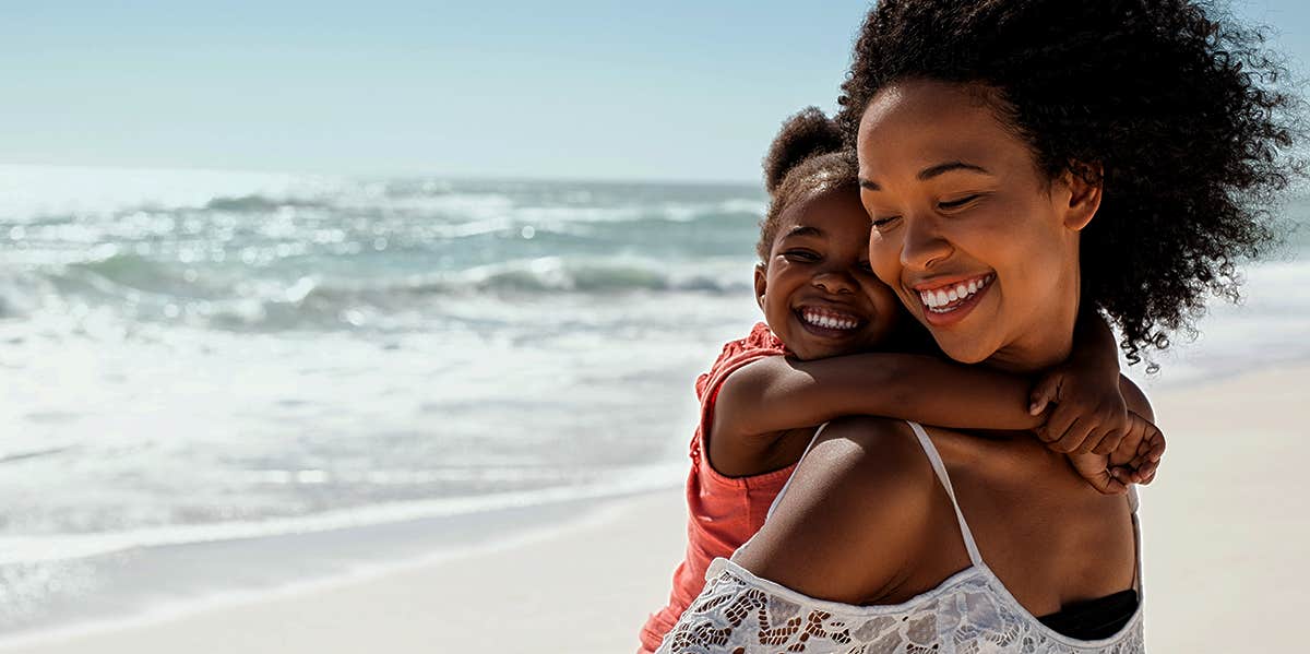 mom and daughter happy at beach