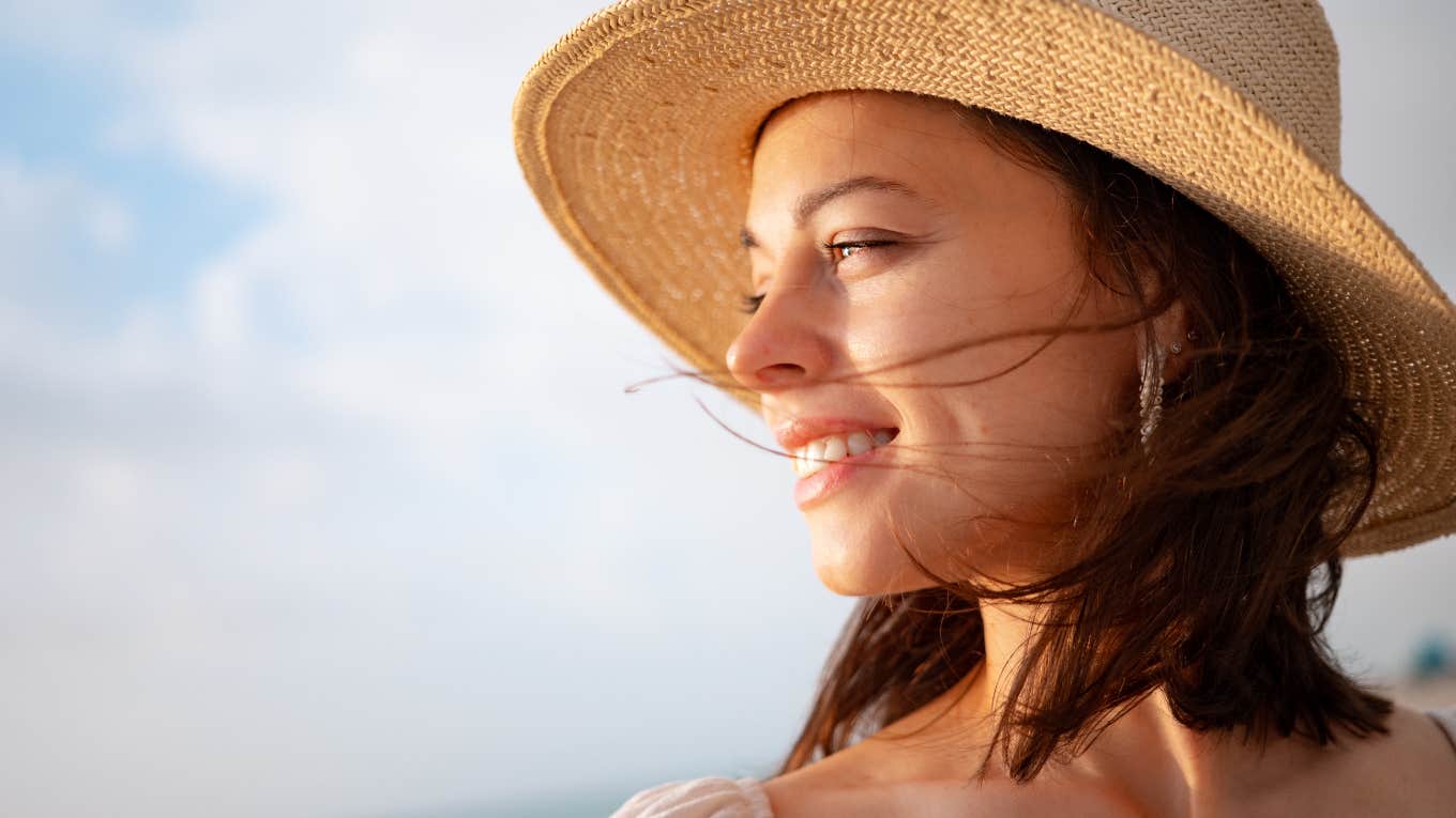 woman smiles gratefully in the sun