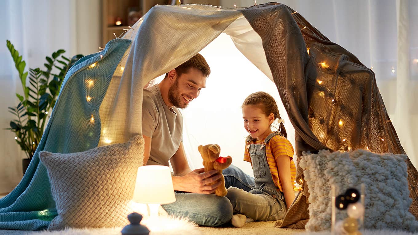 father in tent with children