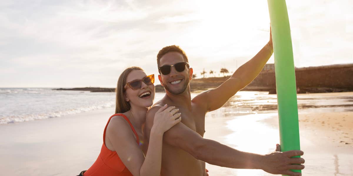 beach couple surfing