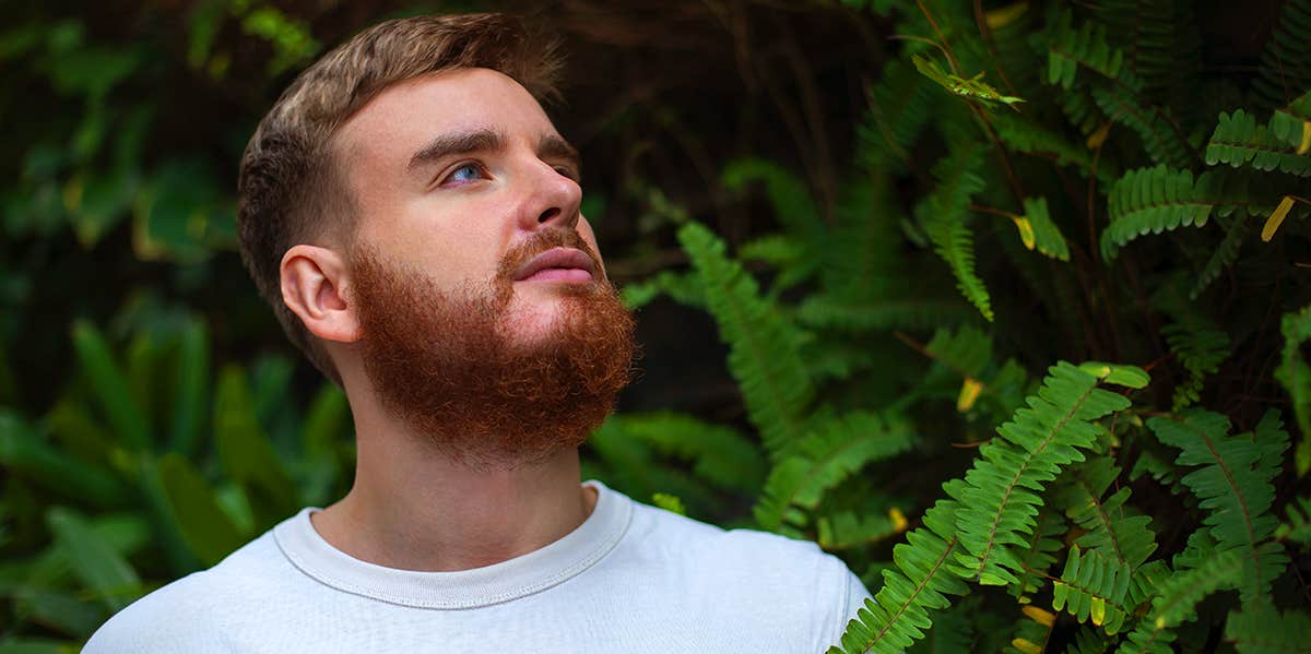 guy in front of greenery