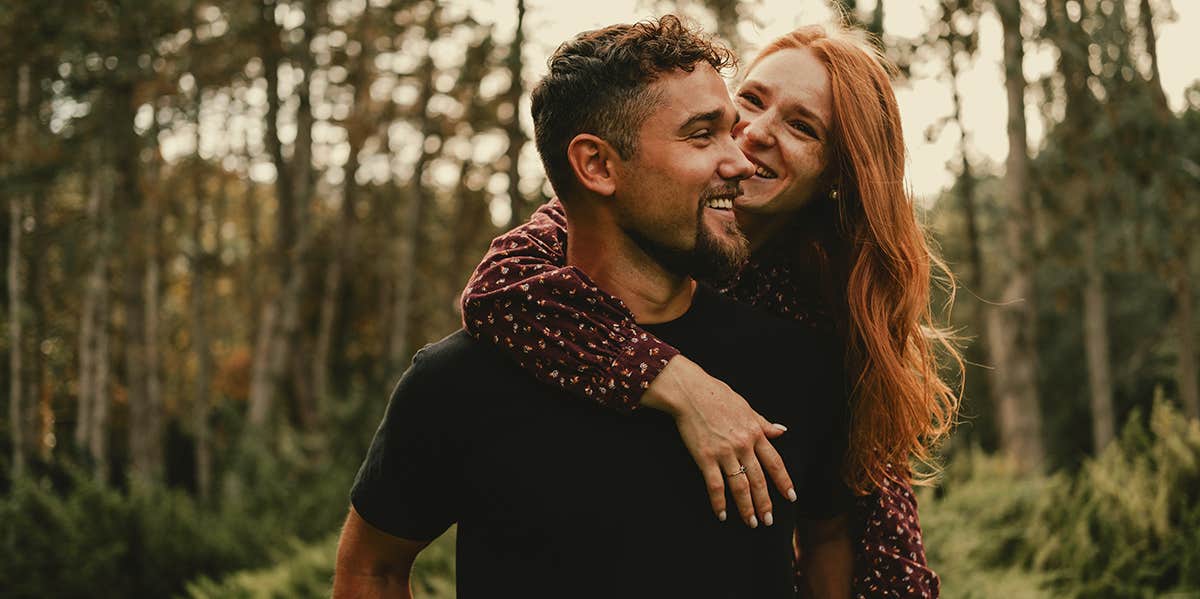 man carrying woman