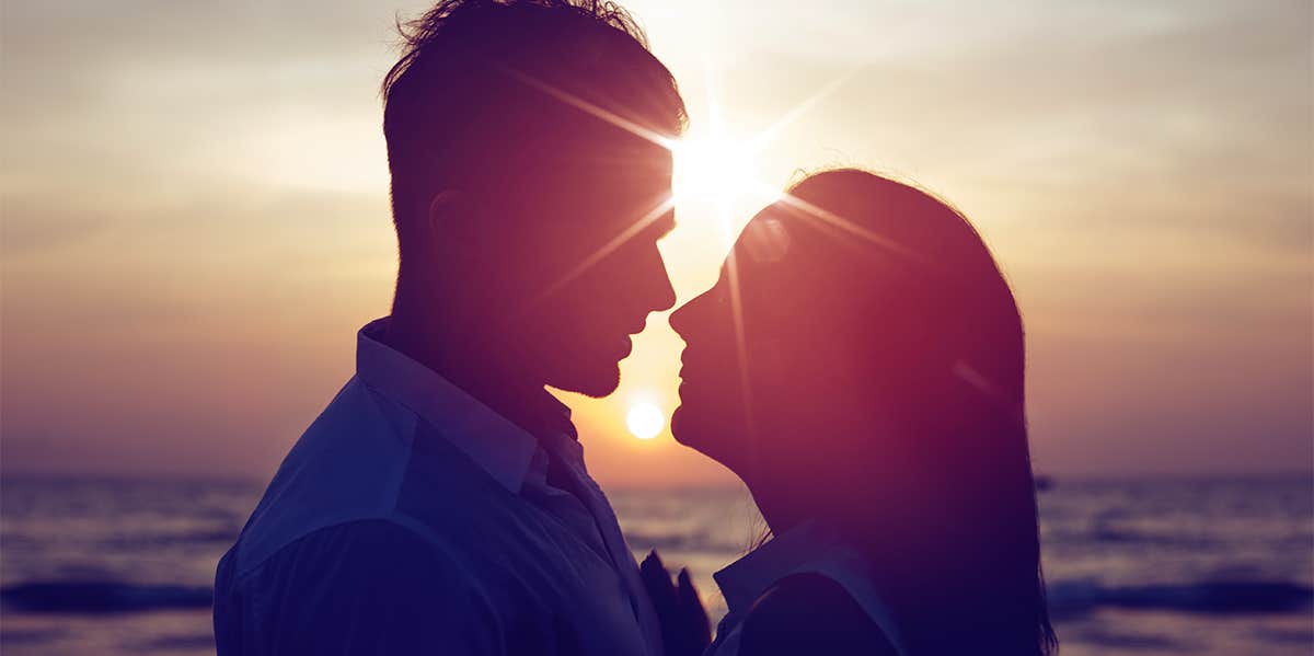 couple kissing at sunset on the beach