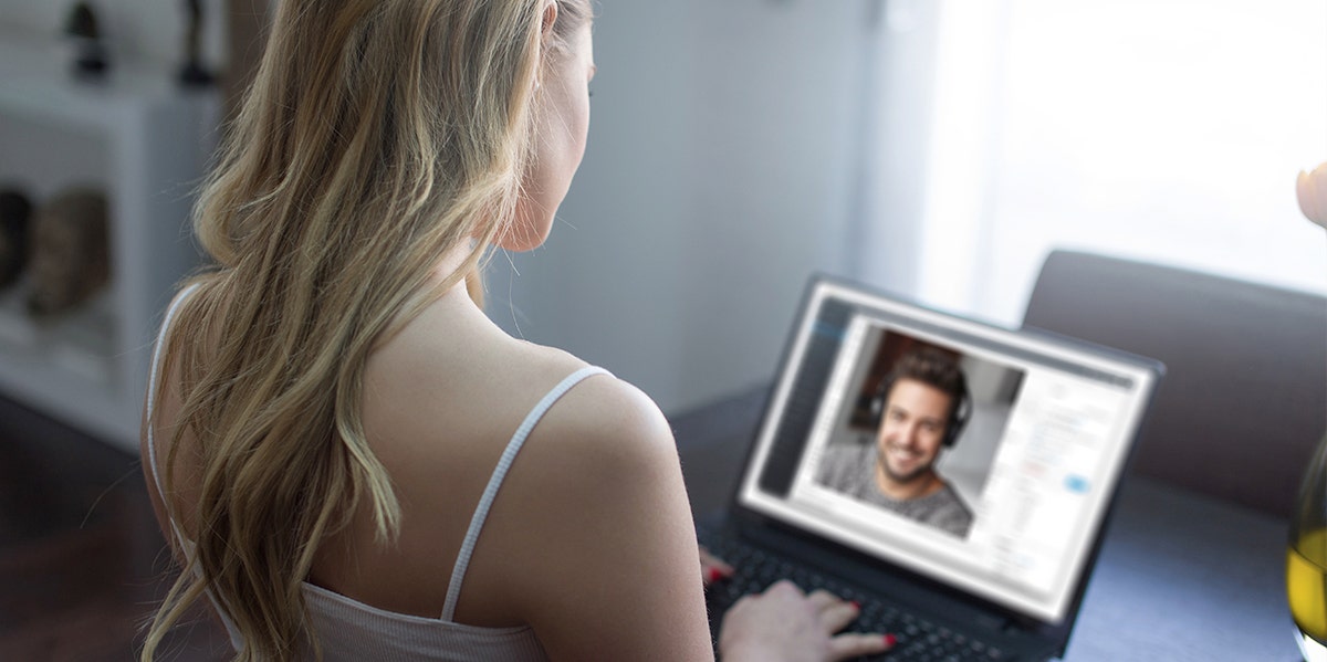 woman looking at computer screen man on screen