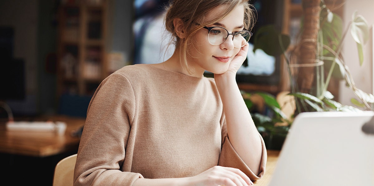 woman on computer scrolling dating ads