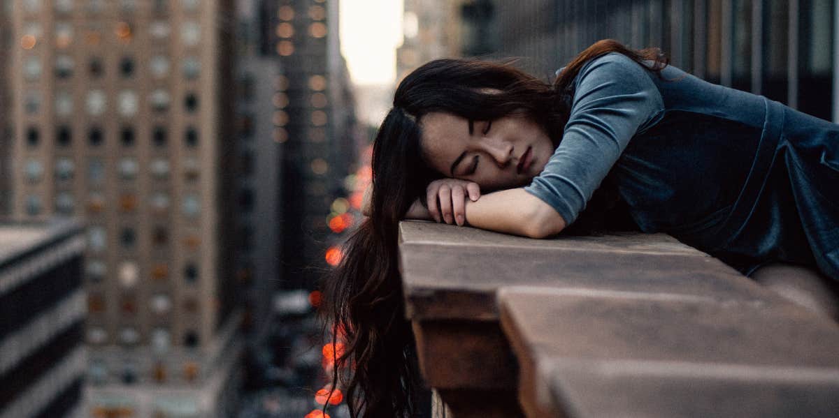 woman laying on side of building