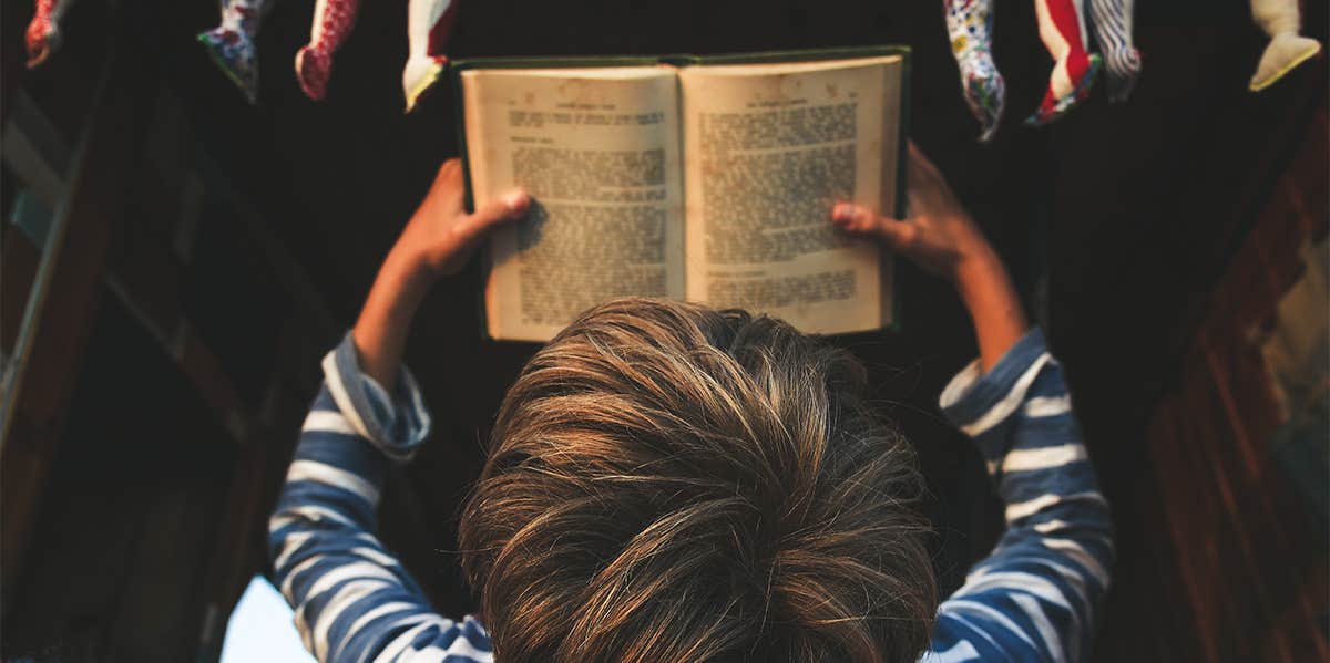 little boy reading book