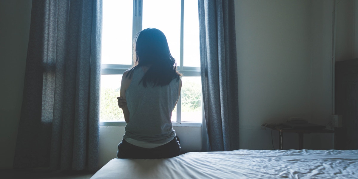 woman sitting on bed 