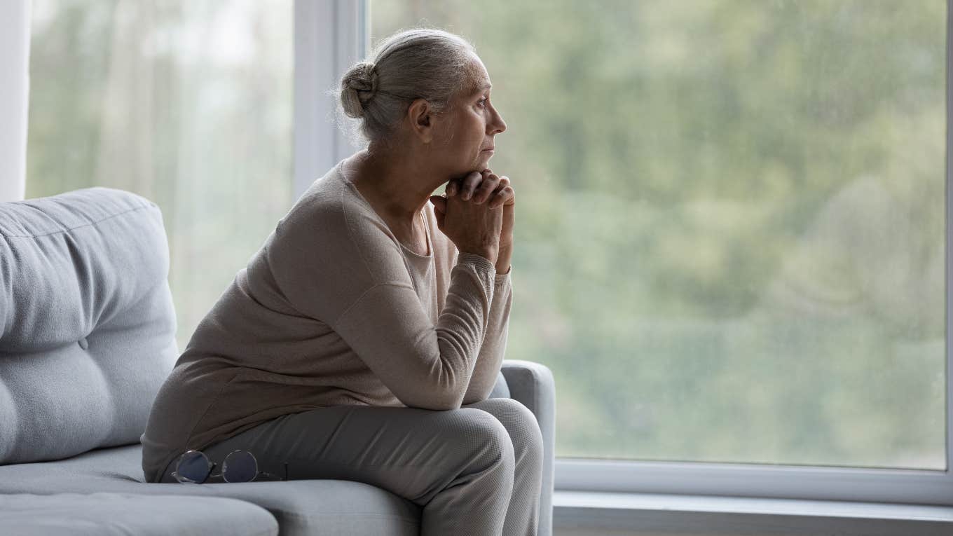 older woman looking out the window