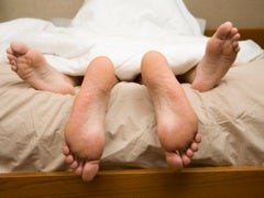 Women Are Warming Up To Oral Sex: Big Deal? feet of couple in bed