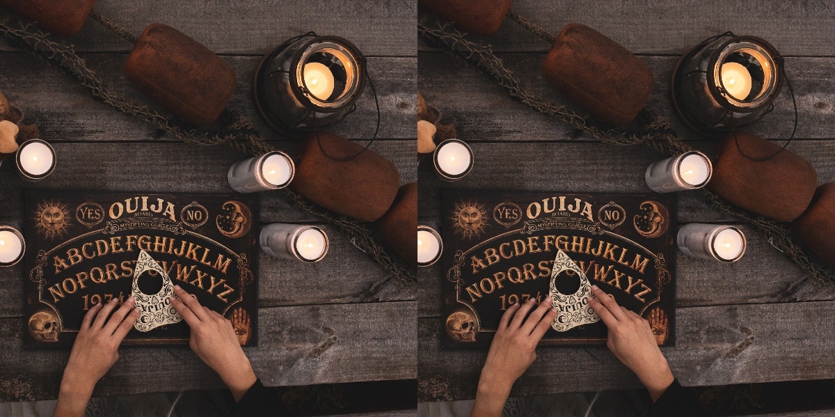 hands on planchette and ouija board