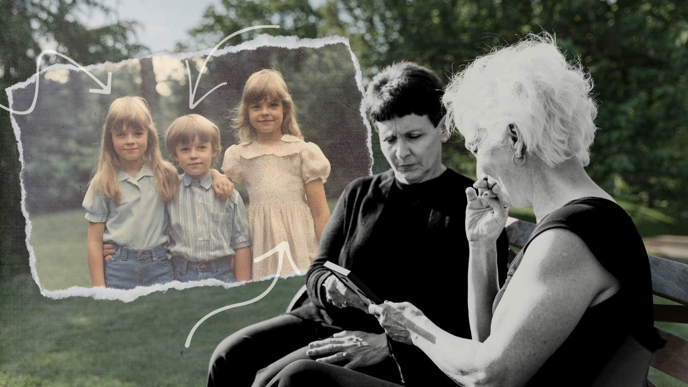 Two siblings looking at a older photo of their baby brother