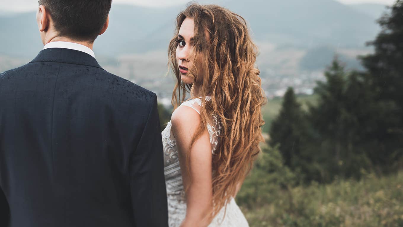 serious woman looking over her shoulder with her partner