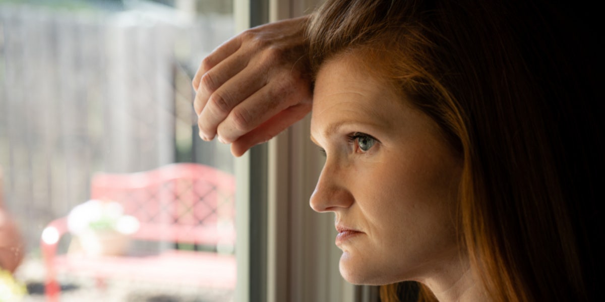 woman looking out window