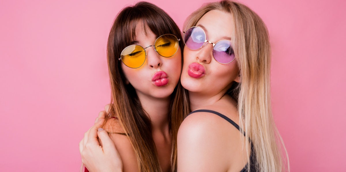 two best friends making kissing face wearing sunglasses