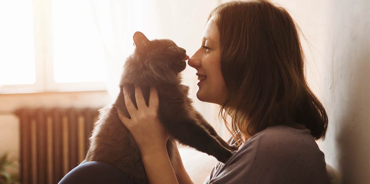 woman holding cat