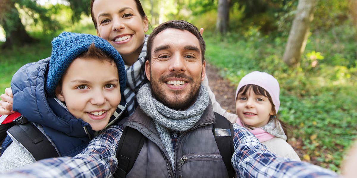 photo of family of four in forest