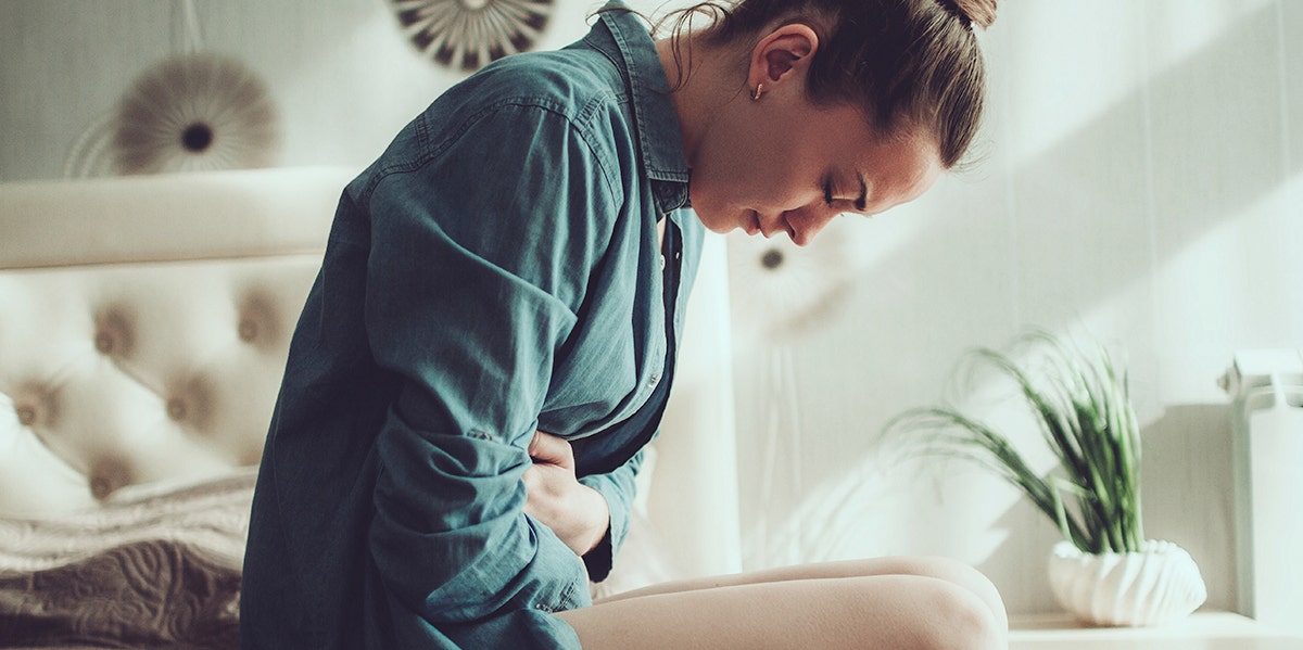 woman leaning over bed