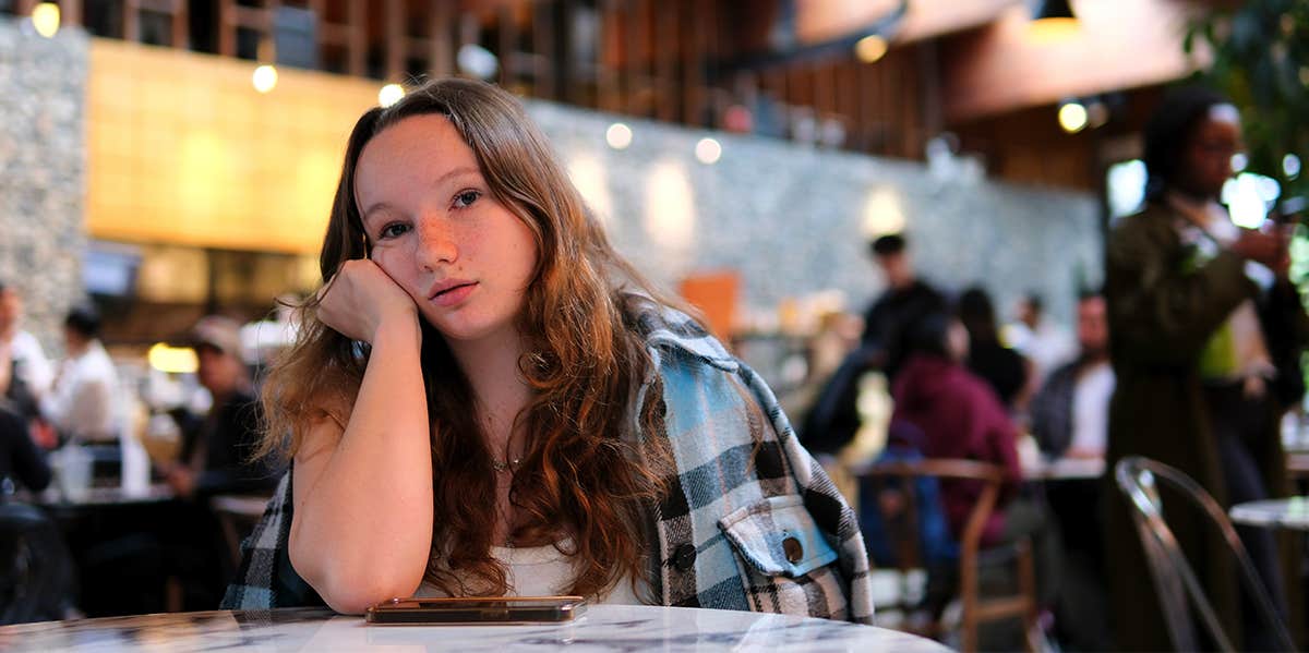 single woman alone at cafe